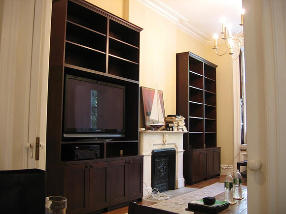 Custom built-in bookshelves and wall unit at Perry Street. Custom Bookshelves around the Fireplace, Manhattan by OzanCraft NYC.