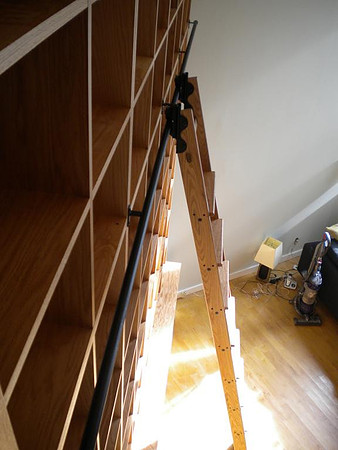 Custom built-in bookshelves and wall unit at Bleecker str. Tall Oak Library Bookshelves with Rolling Ladder, Manhattan by OzanCraft NYC.